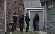 Lawrence police investigate the scene where a dead body was discovered Sunday afternoon in a creek bed and wooded area in the 700 block of Michigan St. near Hawk's Pointe Apartments I.