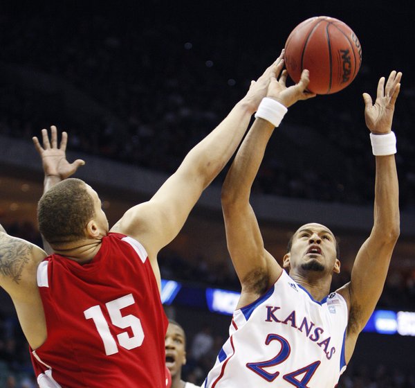 Boston University forward Dom Morris tips the ball away from Kansas guard Travis Releford in the first half of a Southwest Regional NCAA tournament second round college basketball game, Friday, March 18, 2011 in Tulsa, Okla.