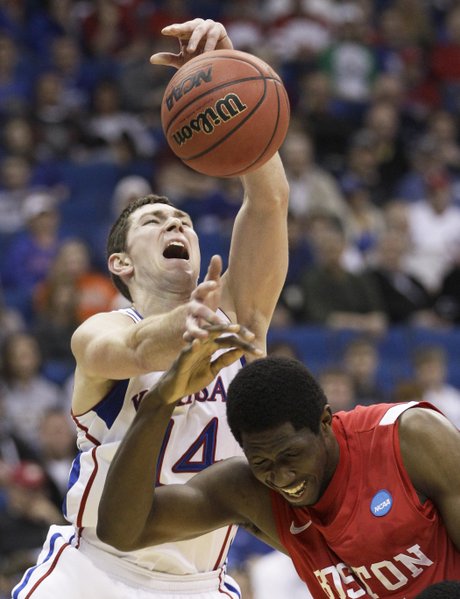 Kansas guard Tyrel Reed and Boston University forward Patrick Hazel battle for a rebound in the first half of a Southwest Regional NCAA tournament second round college basketball game, Friday, March 18, 2011 in Tulsa, Okla.
