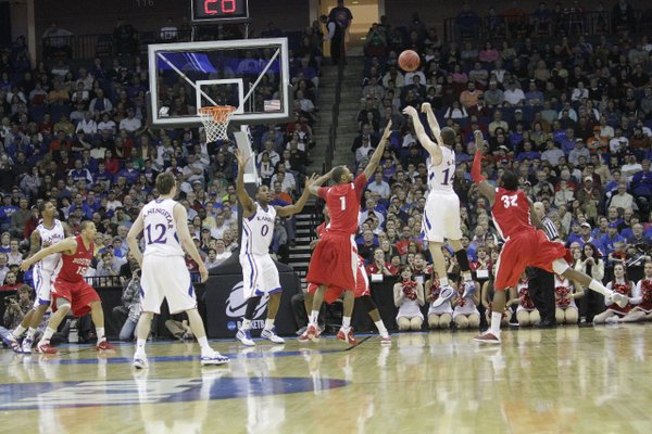 Tyrel Reed shoots a three-pointer over the Boston University defense Friday, March 18, 2011 at the BOK Center in Tulsa.