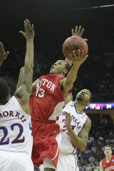 Boston University's D.J. Irving splits Kansas defenders Marcus (22) and Markieff Morris on Friday, March 18, 2011 at the BOK Center in Tulsa.