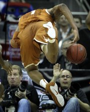 Lawrence Journal-World photographer Nick Krug, right background, prepares for a collision. Crashes like this one are one of the many pitfalls that come with shooting sports from the sidelines.