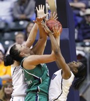 Notre Dame’s Becca Bruszewski, center, goes up with a shot against Connecticut players Stefanie Dolson, left, and Tiffany Hayes. The Irish stunned UConn, 72-63, in a national semifinal Sunday in Indianpolis.