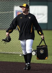 Wichita State pitcher — and Lawrence High grad — Albert Minnis collects practice balls before WSU’s March 18 game in Wichita. Minnis has served a 30-game suspension since February, missing half of his first college season, after running afoul of an NCAA rule about agents.