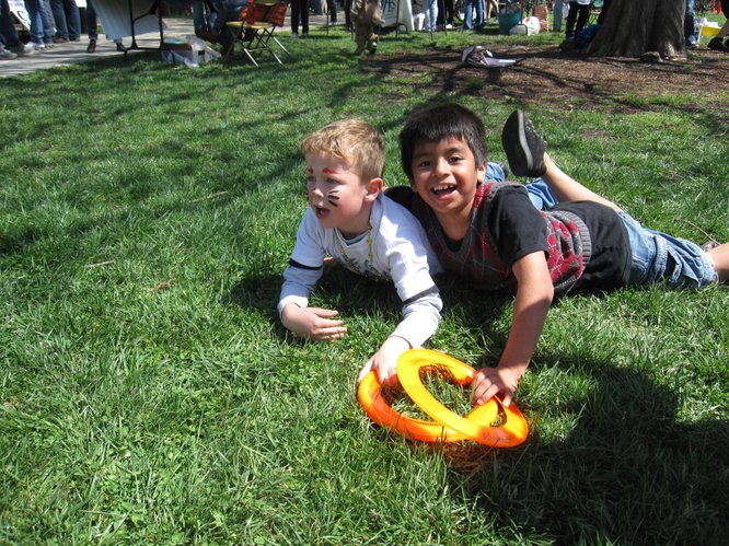 Eli Ditto, 6, left, and Daniel Rojo, 8, both of Lawrence, were playing with Frisbees and chasing each other around South Park during the Earth Day Celebration.