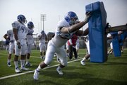 Kansas defensive end Toben Opurum hits the sled during football practice on Monday, April 18, 2011 at the practice fields near Memorial Stadium.