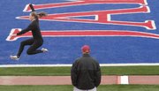Iowa State track coach Pete Herber watches heptathlon athlete Anna Holtermann practice the long jump Tuesday at Kivisto Field at Memorial Stadium. The heptathlon and decathlon start at 10 a.m. Wednesday to kick off the Kansas Relays.