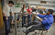 For a project in a Mechanical engineering class, KU students are constructing an exercise machine for people with cerebral palsy who are confined to a wheelchair. Testing their machine Wednesday in Learned Hall, from left, are KU seniors Alex Porter, Hollie Benson, Katie Sanders and Sakeeb Mehdi.
