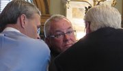 Kansas House Speaker Mike O'Neal, center, a Hutchinson Republican, confers with Rep. Clay Aurand, left, a Courtland Republican, and Majority Leader Arlen Siegfreid, right, an Olathe Republican, while presiding over a debate on pensions legislation Tuesday, May 10, 2011. The bill attacking the long-term funding problems of Kansas' public pension system won final approval Tuesday from the Legislature.