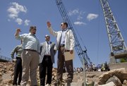 Gov. Sam Brownback, right, looks over the Kansas River and visits with Kellen Petersen, left and Jeff Thorn, center, both engineers with Olsson Associates, about the $20 million project to build a new hydroelectric power plant on the north bank of the Kansas River. A groundbreaking ceremony was held Monday for the project.