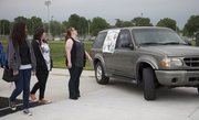 Lawrence high school students look over a Ford Explorer that will be given away in a drawing at Project Graduation. The vehicle was on display Friday, May 27, 2011, at the high school during a rehearsal for the LHS graduation ceremony Sunday.