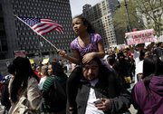 A girl waves an American flag while participating in a rally for jobs and immigration rights in New York May 1, 2011. Almost every state in the union decided to tackle immigration on its own this year in the absence of any federal action on the issue. But an Associated Press review of the data found that as of Wednesday almost all of the punitive measures failed.