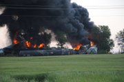 Flames and smoke from burning boxcars containing ethanol alcohol attached to a Union Pacific train are seen south of Moran Monday, May 23, 2011. There were no injuries in the derailment, which prompted officials to close a 23-mile stretch of U.S. 59 south of Moran.