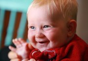 Four-month-old Storm smiles in Toronto in a May 7 photo. Toronto couple Kathy Witterick, 38, and David Stocker, 39, are raising Storm to be genderless. They have shared his or her sex only with sons Jazz, 5, and Kio, 2, a close family friend and two midwives who helped deliver the baby.