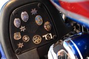 Along Harry Herrington’s journey, family members have given him these miniature replica badges, as well as photos and other mementoes of their loved ones.