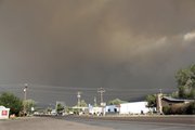 Smoke from a wildfire moves across the sky to the southeast of Eagar, Ariz., Monday, June 6, 2011. Residents in Eagar and nearby Springerville were urged by authorities Monday night to prepare in case evacuations became necessary.