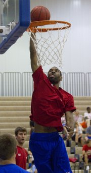 Justin Wesley drills Monday in the Horejsi Center in front of campers in attendance at Bill Self’s basketball camp Monday, June 13, 2011.