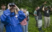 Casey Wright, Baldwin City, foreground left, and other participants in a Saturday, June 25, Kansas Land Trust Bird Walk, spot an Indigo Bunting in a section of the Baldwin Woods. The walk was through the Earles Easement, a 135-acre wooded area with trails near the southeast corner of Douglas County State Fishing Lake.