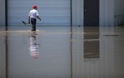Ron Bachman, owner of St. Joseph Petroleum in St. Joseph, Mo., wades through Missouri River floodwaters to inspect his property Tuesday, June 28, 2011. Bachman was able to move his business to other locations because of the advance warning of the high water.