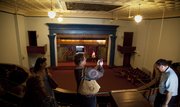 Deb Drummet, of Capital City Bank, uses her cell phone to capture a picture from the balcony of the Masonic Temple building during a tour Wednesday, June 29, 2011. Stephen Maceli, owner of Maceli's, is considering converting the historic building to host weddings and catered events.