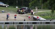 Douglas County Underwater Search and Recovery Team members search the swim beach area at Lone Star Lake for a missing seven-year-old Kansas City, Mo. boy on Saturday, June 2, 2011. The crew suspended their search for the night due to darkness and will resume at first light on Sunday.