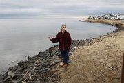 In this Feb. 24, 2010, picture, Regina Discenza stands on the shore of Barnegat Bay, near her home in Lacey Township, N.J., as she talks about the fears of water discharged from the nearby Oyster Creek nuclear plant. At the 41-year-old facility in southern New Jersey, the country's oldest operating reactor, the latest tritium troubles started in April 2009, a week after it was relicensed for 20 more years. None has been directly measured in drinking water, but it has been found in an aquifer and in a canal discharging into nearby Barnegat Bay. The bay is a popular spot for swimming, boating and fishing.