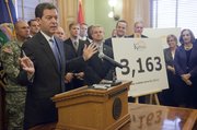 Gov. Sam Brownback provides a progress report on his first six months in office Wednesday, July 6, 2011, at the Statehouse in Topeka. Brownback was joined by Cabinet secretaries and executive directors of state agencies and programs.