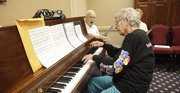 Winnie Gallup plays the piano while her husband, Al Gallup, and others sing along. Members of the Endacott Society, made up of retired KU faculty and staff, got together at the Adams Alumni Center Thursday, July 7, 2011, to sing old songs of the big band era.