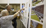 Marilyn Stokstad and Bill Crowe, both of Lawrence, inspects renderings what the Lawrence Public Library will look like after the upcoming redesign project during a “Sneak Peek” party Sunday, July 24, 2011 at the library. The redesign is scheduled to begin in the spring and is expected to take two years to complete.