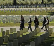 Civil War re-enactors carry the cremains of Civil War veteran Pvt. George McCarthy to his final resting place at the national cemetery at Fort Leavenworth Tuesday, July 26, 2011.