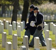 Civil War re-enactors Bob Wande, right, from Lawrence, and Perry Marks, from Holton, Mo., carry the cremains of Civil War veteran Pvt. George McCarthy to his final resting place at the national cemetery at Fort Leavenworth Tuesday, July 26, 2011. McCarthy died at age 102 in Missouri, but for almost 70 years his ashes went unclaimed, resting on a shelf a funeral home storage facility in Kansas City.