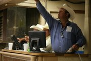 Weston Winter of Winter Livestock Auction mans the auction gate and "yips" for auctioneer Roger Emigh each time he sees a bidder.