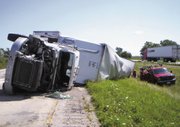 A damaged semitrailer is seen Thursday morning, Aug. 11, 2011, after a collision with a tour bus carrying Nickelodeon actress and singer Miranda Cogrove, 18, along Interstate 70 near Vandalia, Ill., 70 miles northeast of St. Louis. Cosgrove broke her ankle in the accident. A spokesperson says Cosgrove's "Dancing Crazy Summer Tour" is postponed until further notice. She was scheduled to perform Friday in Wichita and Saturday in Denver.