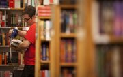 Ian Hrabe, a 2009 Kansas University graduate prices books at his job, Thursday, Aug. 11, 2011, at Half Price Books. Hrabe is one of many recent grads saddled with a large amount of debt from student loans and private loans. He estimates that he owes about $60,000.