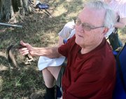 Charles Hill shows off a pair of horseshoes at the Vinland Fair on Thursday, Aug. 11, 2011. His father, Earl Hill, won them at the fair in 1926.