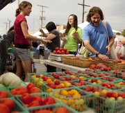 Gregory Rudnick, of Lawrence, weighs his options while selecting tomatoes from Jennifer Kongs, a seller at the Avery's Produce stand, left, on Saturday, Aug. 20, 2011 at the Downtown Lawrence Farmers' Market.