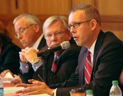 Sen. Tim Owens, center, listens to Rep. Paul Davis, right, of Lawrence, give his thoughts on redistricting during a hearing at the Dole Center of Politics on Sept. 2, 2011. Local residents and officials came to the hearing to tell legislators what they wanted out of the process.