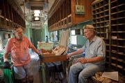 Former railroad mail clerks Eldon Denney, Springfield, Mo., left, and Herb Crawford, Osawatomie, reminisce about working in the mail car during a ride Saturday at the Railroadiana Labor Day Railfest at Midland Railway in Baldwin City, Saturday, Sept. 3. Rides continue through Monday.