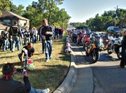 Members of the Lawrence Sport Bike Association took a memorial ride in honor of Josh Skipton, who was killed in a wreck on Iowa Street, and stopped at the crash site, where a cross has been placed. The group included Ahmed Alyousef, kneeling at the cross, and Matt Kaufmann, standing at center.