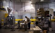 Alonzo Robinson, a 54-year-old machine operator, sorts through packets of concrete cleaner for packaging during his shift on Thursday at Prosoco, 3741 Greenway Circle. Unhappy with his former full-time job, Robinson quit for a temporary position with Prosoco that eventually turned full time.