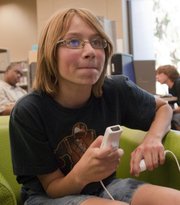 Nathan Fletchall, 12, concentrates on a game of “Super Smash Bros. Brawl,” on Oct. 5 at the Lawrence Public Library, 707 Vt. The library plays host to a teen video game tournament once a month.