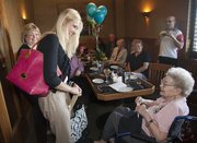 Bertie McConnell, right, celebrated her 90th birthday Saturday with a little surprise added when she was inducted in the Zeta Tau Alpha sorority by Washburn University chapter president Paige Martin, center.
