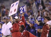 Image boards featuring NFL icons are held up from the Kansas bench during Saturday's home game against Oklahoma as what was later explained to be an attempt to simplify the play calling.