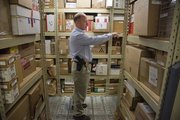 Officer Keith Jones checks the third level of the evidence room at the Judicial and Law Enforcement Center, 111 E. 11th St. Crime evidence is housed in various locations and space is getting tight.