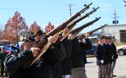 Veterans of Foreign Wars members fire a 21-gun salute Friday to honor military personnel on Veterans Day at VFW Post 852 in Lawrence.
