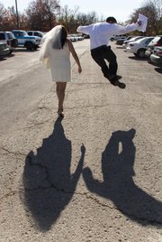 Joel Carbough, right, jumps in the air in an attempt to click his heels after he and Felicia Hernandez got married Friday, Nov. 11, 2011, at the Douglas County Judicial and Law Enforcement Center at 111 E. 11th St.