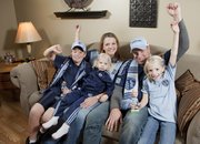 The Urban family are big fans of Sporting Kansas City, a Major League Soccer team. Julie and her husband Brandon cheer at home with their children, from left, Ben 10; Molly, 2; and Grace, 8.