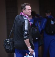 Kansas head coach Bill Self smiles as the team heads for their bus after arriving at the Kahului Airport on Friday, Nov. 18, 2011 in Maui.