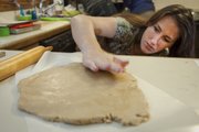 Jena Dick checks the thickness of her dough after rolling it out. She is making a gingerbread house that will be a fireplace structure with Santa wedge in the fireplace. The structure will be part of The Gingerbread House Festival and Auction that will benefit Big Brothers Big Sisters.