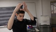 Kansas University senior Jason Charney, of Overland Park, shakes an iPhone that he uses to perform music he has created using the device.